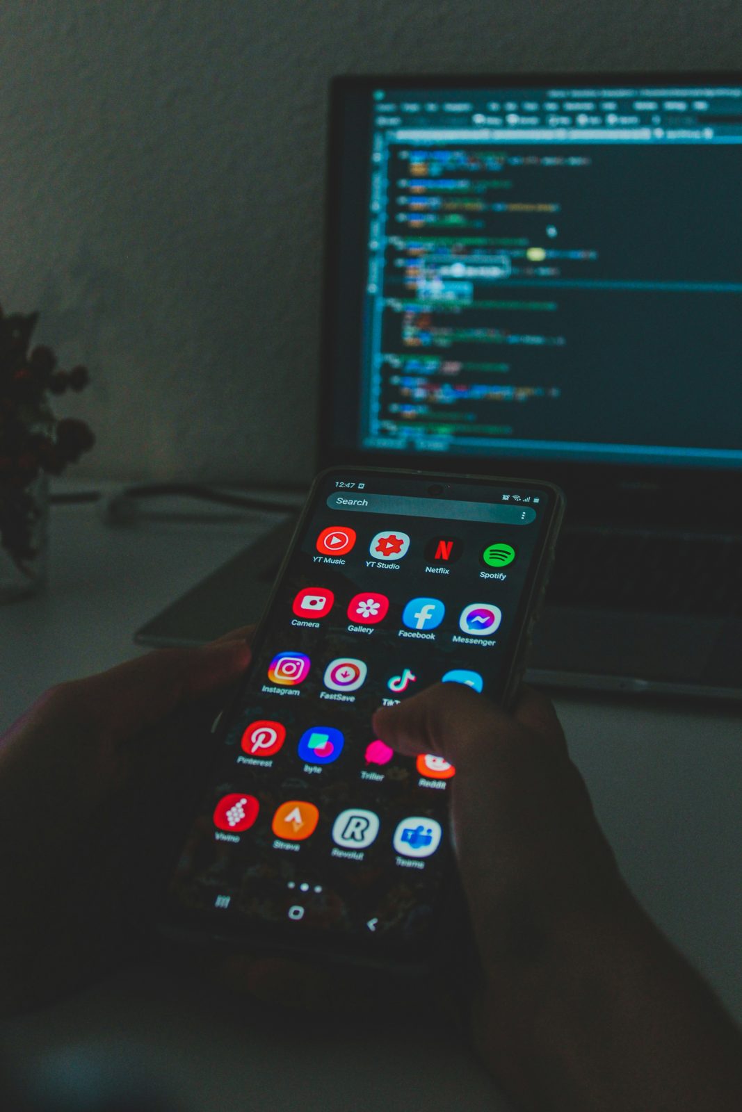 Mobile app developer reviewing an application interface design on a smartphone